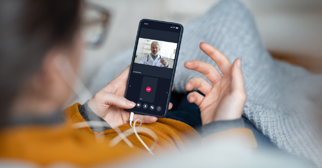Patient on a video call with a physician using a telehealth app on a smartphone
